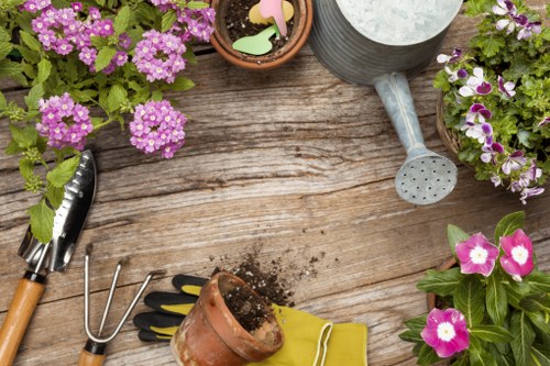 Gardener preparing tools beside a neat lawn — safety and insurance focus